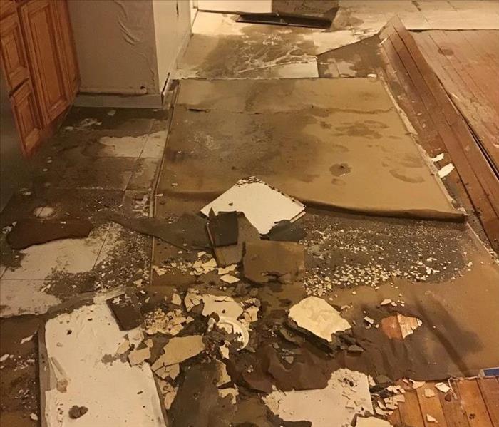 residential water damage with floor and cabinet damages
